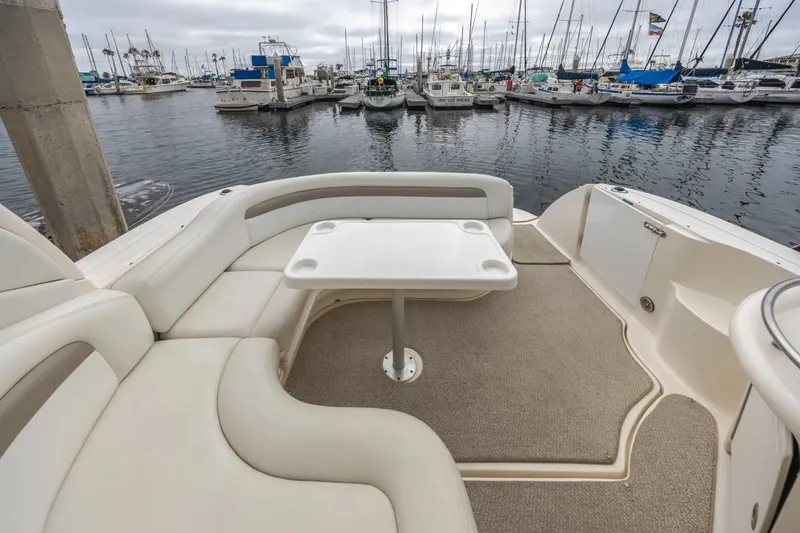 Slide: The Image of 2006 Sea Ray 340 Sundancer yacht interior with seating and table, docked at marina. - 11