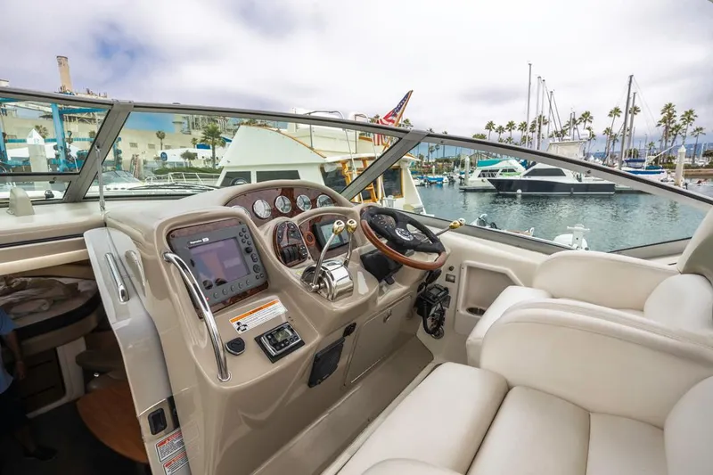 Slide: The Image of Helm of 2006 Sea Ray 340 Sundancer with marina view in background. - 13
