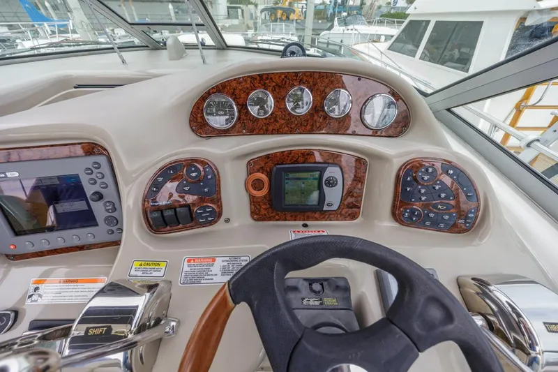 Slide: The Image of Helm of 2006 Sea Ray 340 Sundancer with navigation controls and gauges. - 15
