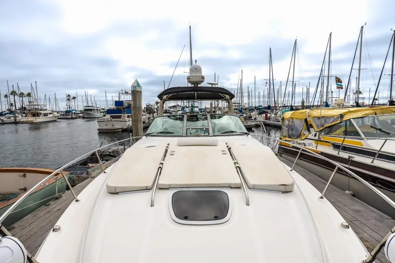 Slide: The Image of 2006 Sea Ray 340 Sundancer yacht docked in a marina with sailboats. - 18