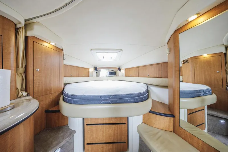 Slide: The Image of Interior of 2006 Sea Ray 340 Sundancer yacht, featuring a cozy cabin with wood accents. - 23