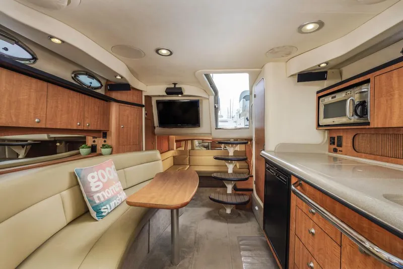 Slide: The Image of Luxurious interior of 2006 Sea Ray 340 Sundancer yacht with modern amenities and cozy seating. - 24