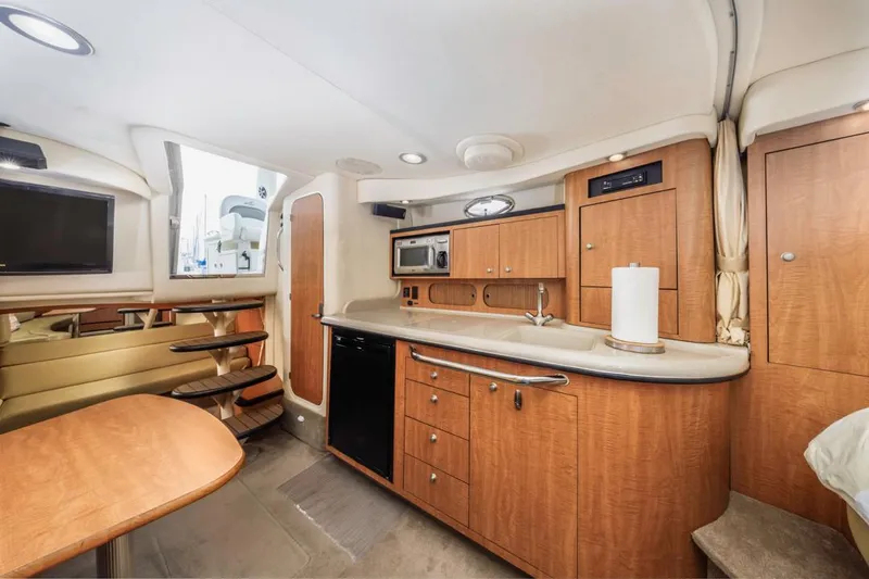 Slide: The Image of Interior of 2006 Sea Ray 340 Sundancer yacht with modern kitchen and seating area. - 25