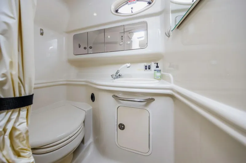 Slide: The Image of 2006 Sea Ray 340 Sundancer bathroom with toilet, sink, and storage cabinets. - 27