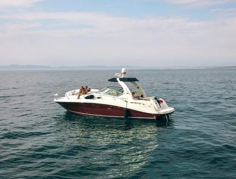 Slide: The Image of 2006 Sea Ray 340 Sundancer yacht cruising on open water under a clear sky. - 3