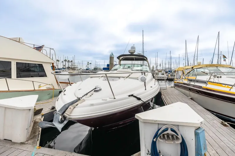 Slide: The Image of 2006 Sea Ray 340 Sundancer docked at marina, surrounded by other boats. - 6