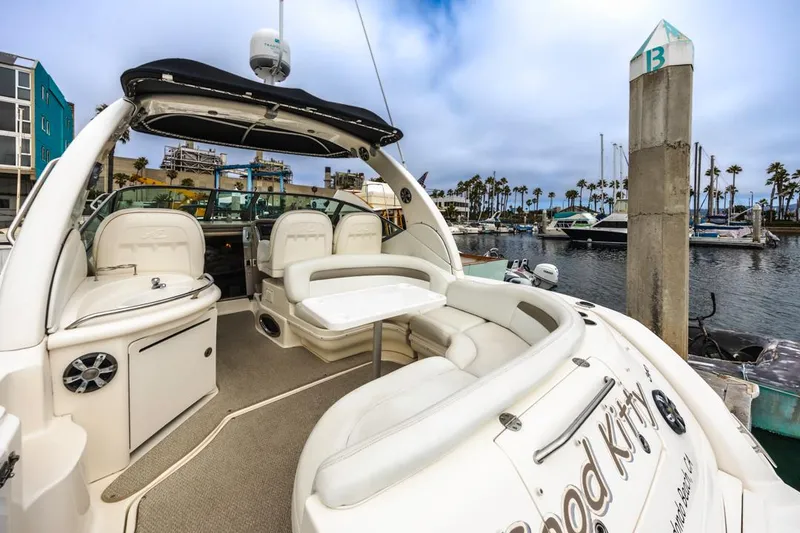 Slide: The Image of 2006 Sea Ray 340 Sundancer yacht docked at marina, featuring spacious seating and sleek design. - 9