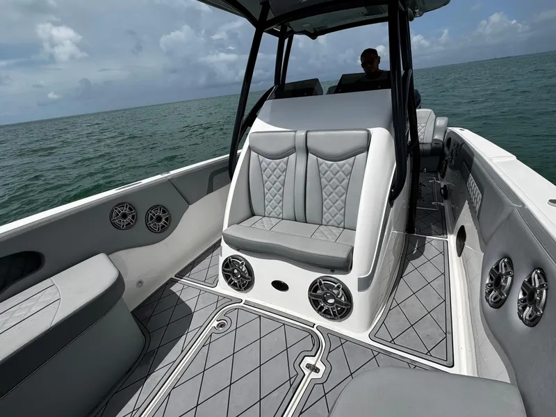 Slide: The Image of 2023 Avanti 36 boat interior with gray seating and ocean backdrop. - 11