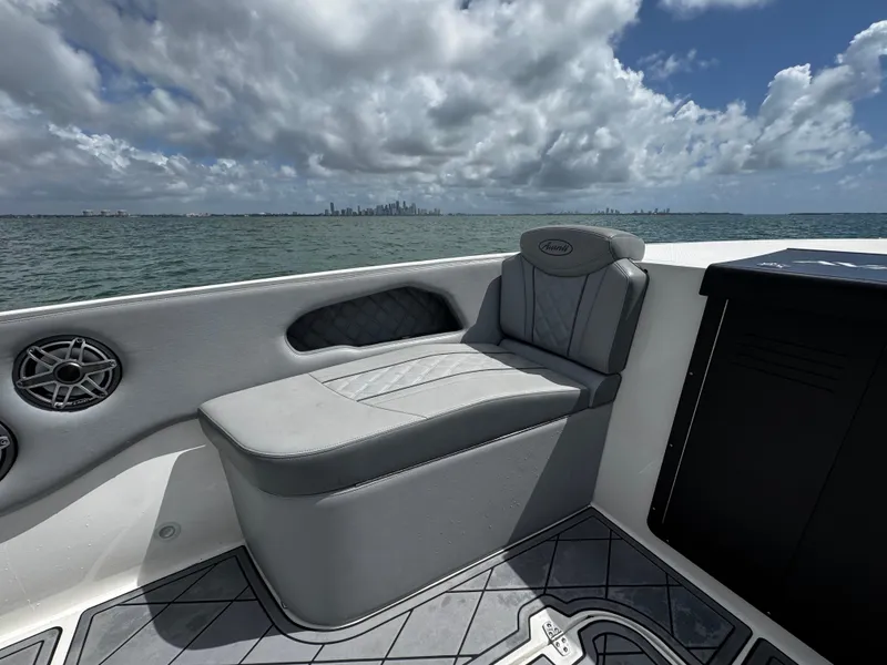 Slide: The Image of 2023 Avanti 36 boat interior with cushioned seating, ocean view, and cloudy sky. - 15