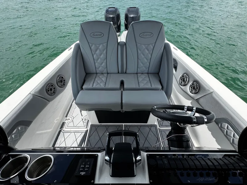 Slide: The Image of 2023 Avanti 36 boat interior with dual seats, steering wheel, and control panel on water. - 20
