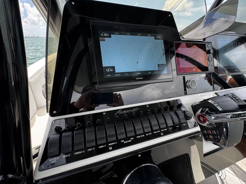 Slide: The Image of Control panel of 2023 Avanti 36 boat with navigation screens and switches. - 24