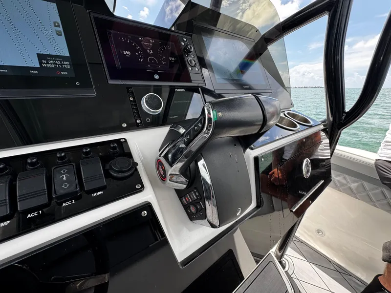 Slide: The Image of Control panel of a 2023 Avanti 36 boat with navigation screens and throttle. - 25