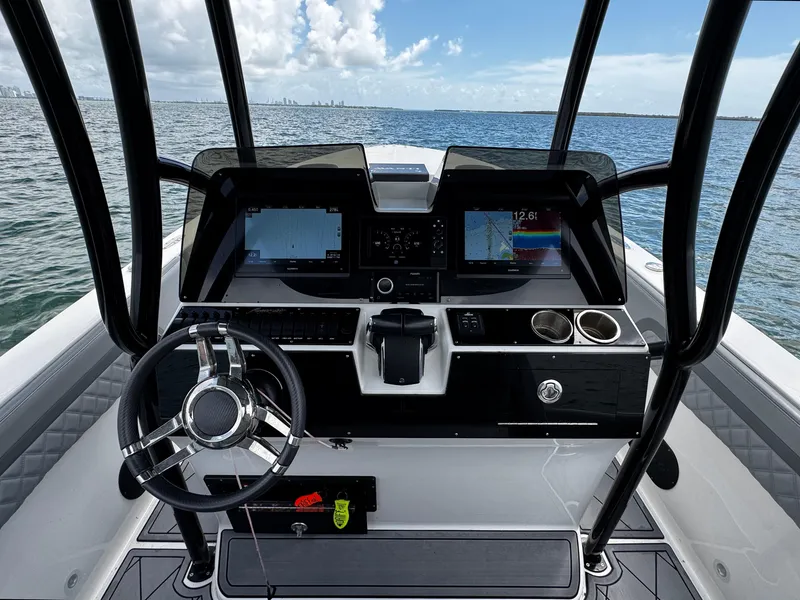 Slide: The Image of 2023 Avanti 36 boat dashboard with steering wheel and navigation screens on open water. - 29