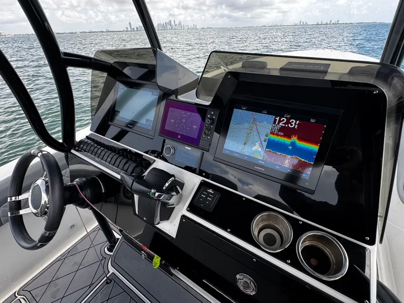 Slide: The Image of Helm of 2023 Avanti 36 boat with advanced navigation displays and steering wheel. - 30