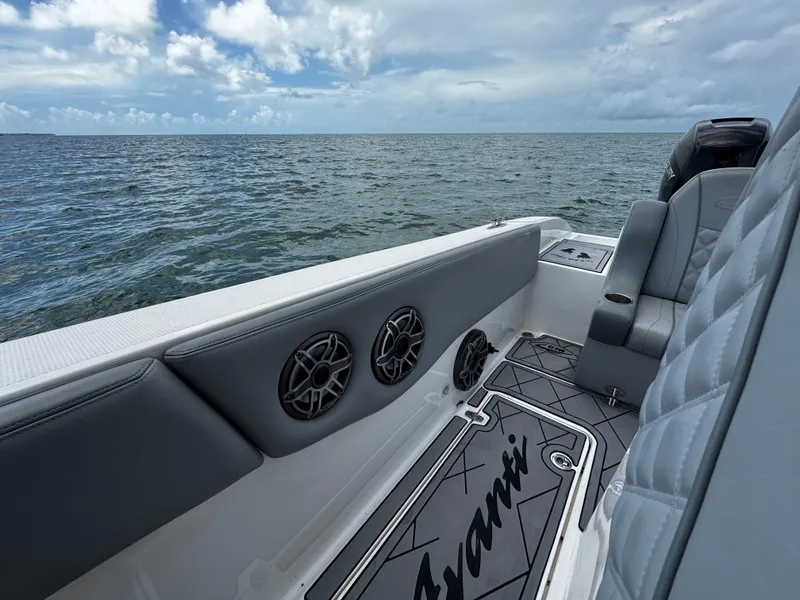 Slide: The Image of 2023 Avanti 36 boat interior with gray seating, speakers, and ocean view. - 32