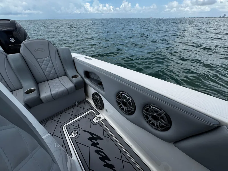 Slide: The Image of 2023 Avanti 36 boat interior with gray seating, speakers, and ocean view. - 33