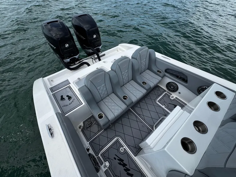 Slide: The Image of 2023 Avanti 36 boat with dual engines, luxury seating, and cup holders on open water. - 34