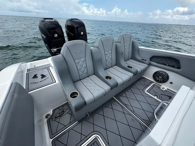 Slide: The Image of 2023 Avanti 36 boat interior with gray seating, cup holders, and dual Mercury engines. - 35