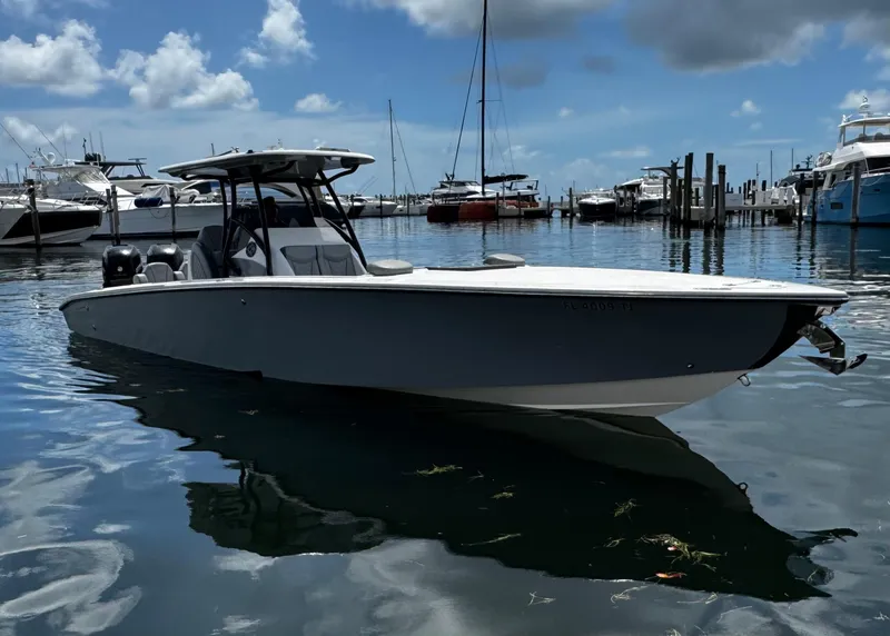 Slide: The Image of 2023 Avanti 36 boat docked in a marina under a partly cloudy sky. - 6