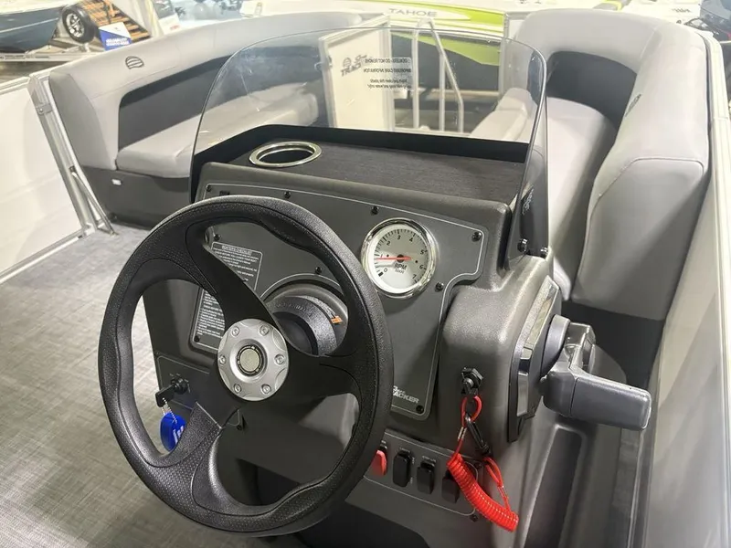 Slide: The Image of 2026 Sun Tracker PARTY BARGE® 16 DLX dashboard with steering wheel and RPM gauge. - 12