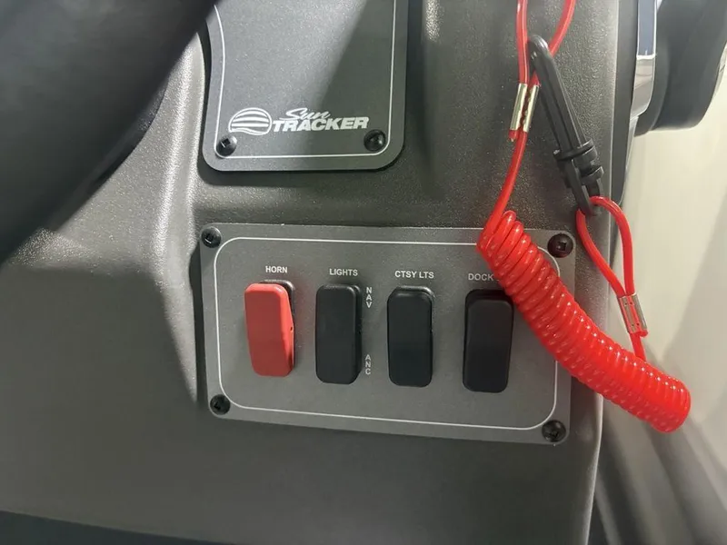Slide: The Image of Control panel of 2026 Sun Tracker PARTY BARGE® 16 DLX with switches and safety lanyard. - 13