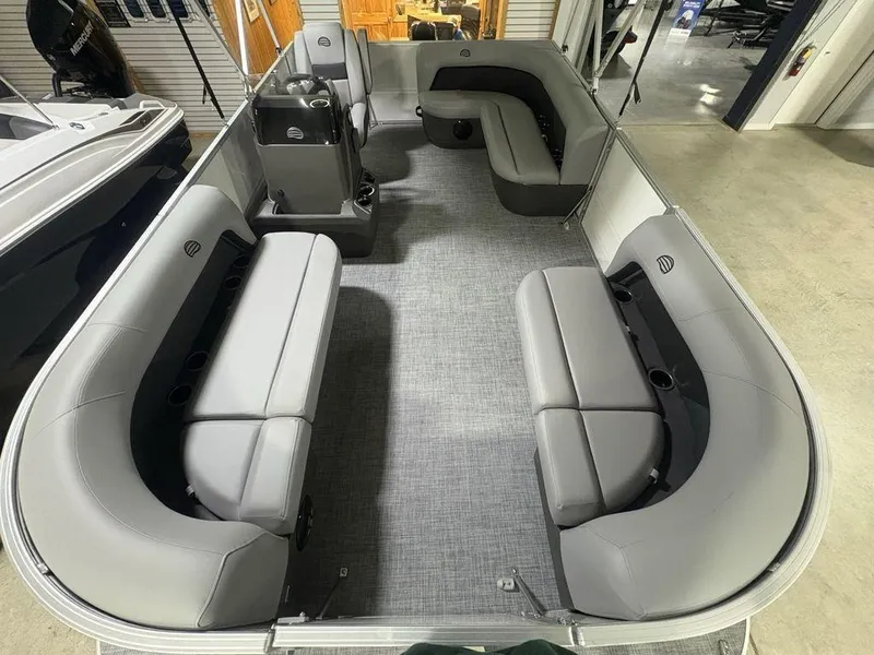 Slide: The Image of 2026 Sun Tracker PARTY BARGE® 16 DLX interior with gray seating and spacious layout. - 18