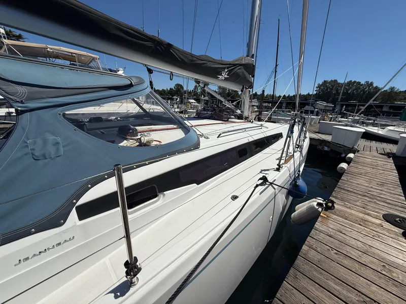 Slide: The Image of Jeanneau Sun Odyssey 410 sailboat docked at marina, 2021 model, side view. - 2