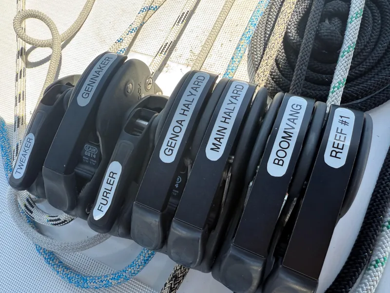Slide: The Image of Sailing controls on Jeanneau Sun Odyssey 410, 2021 model, featuring labeled rope clutches. - 22
