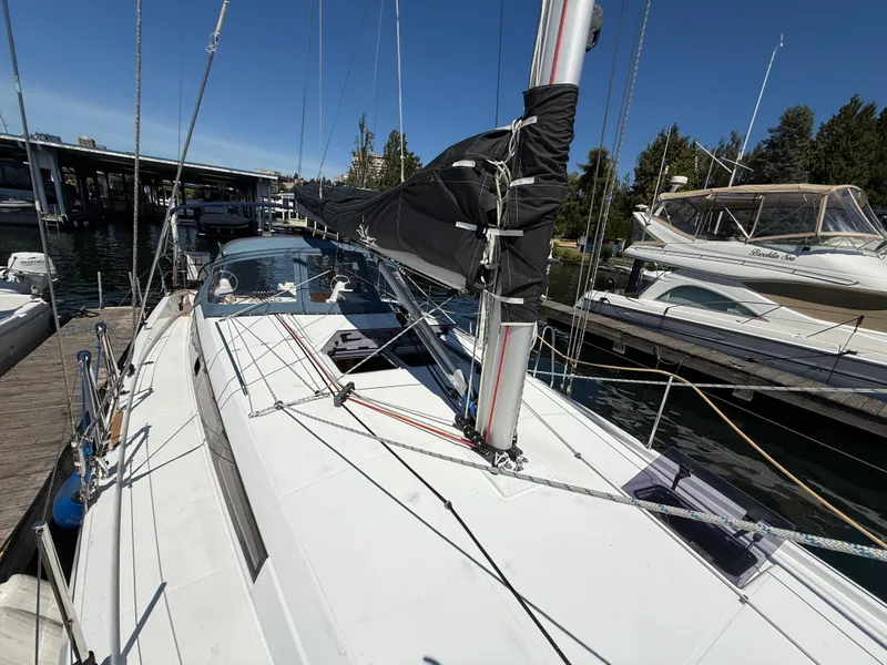 Slide: The Image of 2021 Jeanneau Sun Odyssey 410 sailboat docked at marina under clear blue sky. - 26