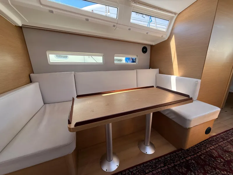 Slide: The Image of Interior of 2021 Jeanneau Sun Odyssey 410 yacht with cozy seating and wooden table. - 7