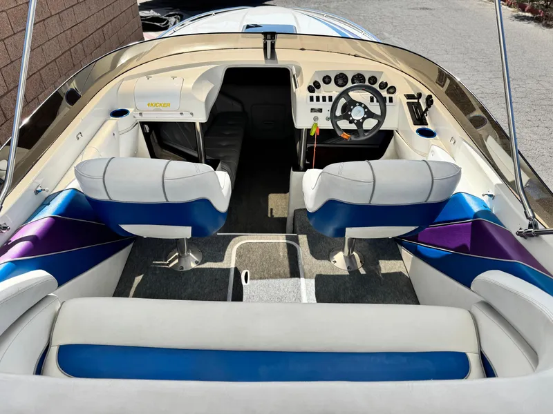 Slide: The Image of Interior of a 1998 Nordic 25 Scandia boat with blue and white seating. - 10