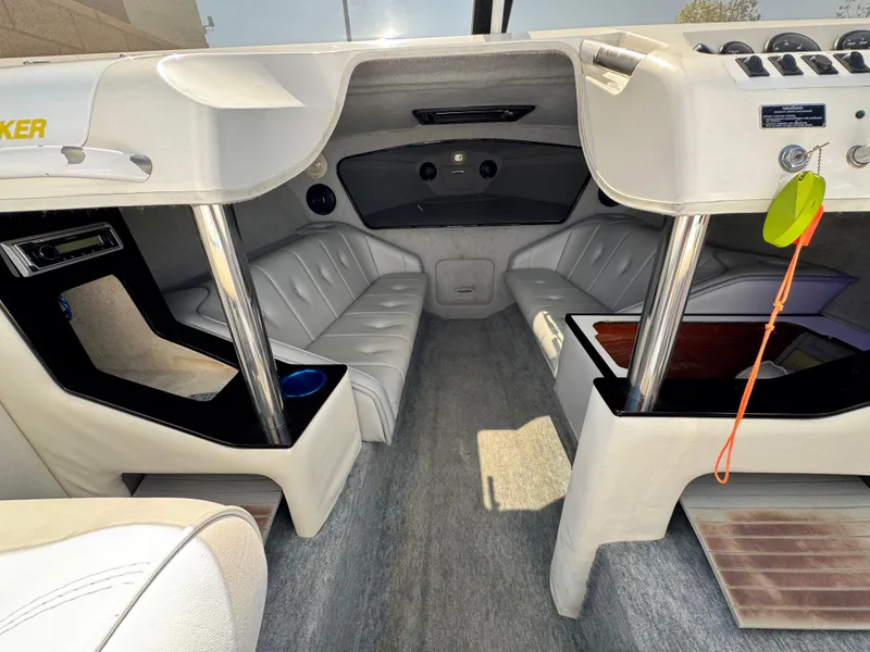Slide: The Image of Interior of a 1998 Nordic 25 Scandia boat with white leather seating and modern amenities. - 12