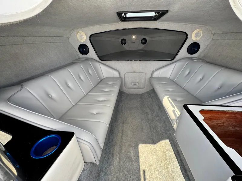 Slide: The Image of Interior of a 1998 Nordic 25 Scandia boat with gray seating and carpet. - 13