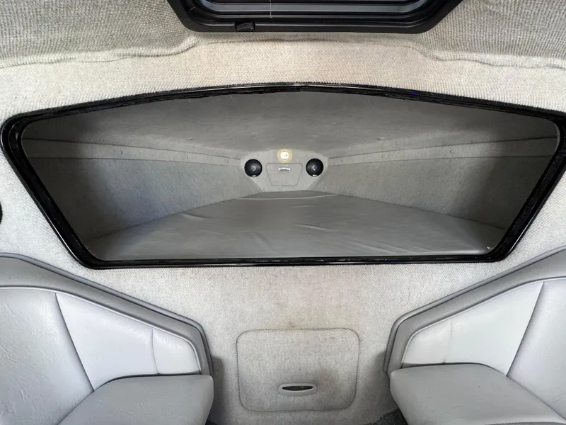 Slide: The Image of Interior cabin of a 1998 Nordic 25 Scandia boat, featuring gray upholstery. - 14