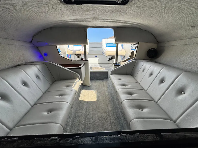 Slide: The Image of Interior of a 1998 Nordic 25 Scandia boat with gray seating and carpet. - 16