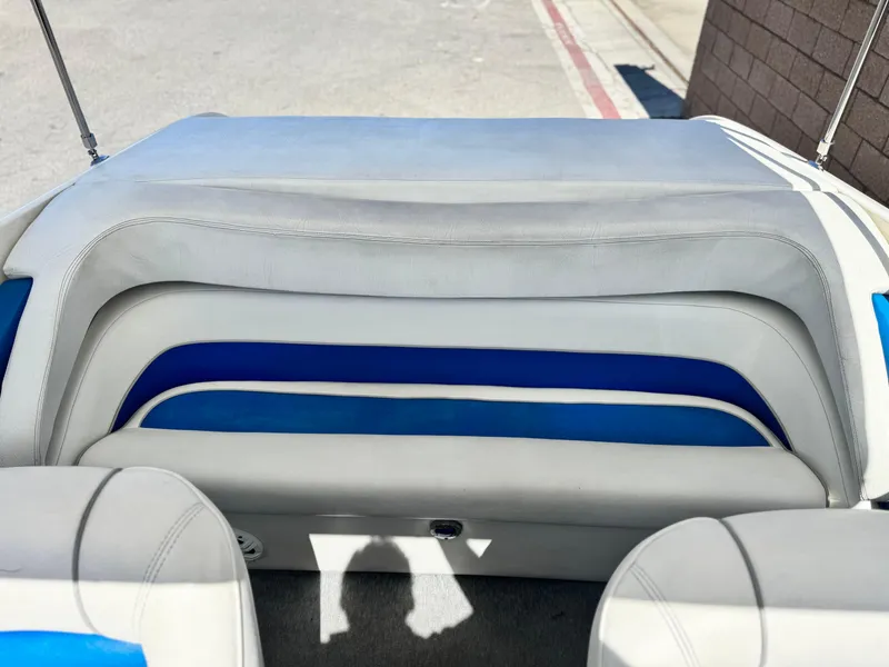 Slide: The Image of Rear seating area of a 1998 Nordic 25 Scandia boat with blue and white upholstery. - 19