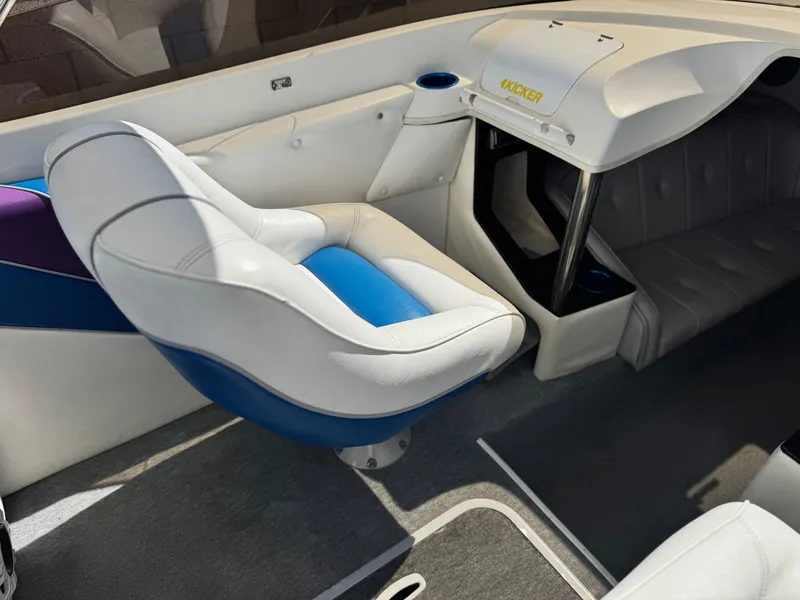 Slide: The Image of Interior of a 1998 Nordic 25 Scandia boat with white and blue seating. - 21