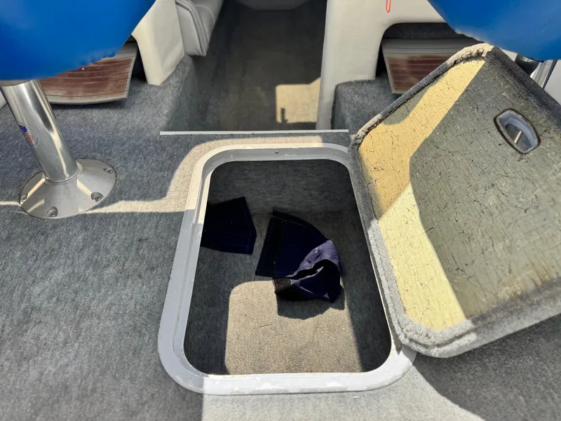 Slide: The Image of Open storage compartment on 1998 Nordic 25 Scandia boat, showing interior details. - 22