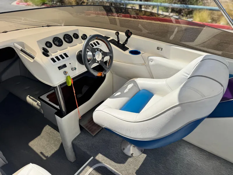 Slide: The Image of Interior of a 1998 Nordic 25 Scandia boat with steering wheel and controls. - 23