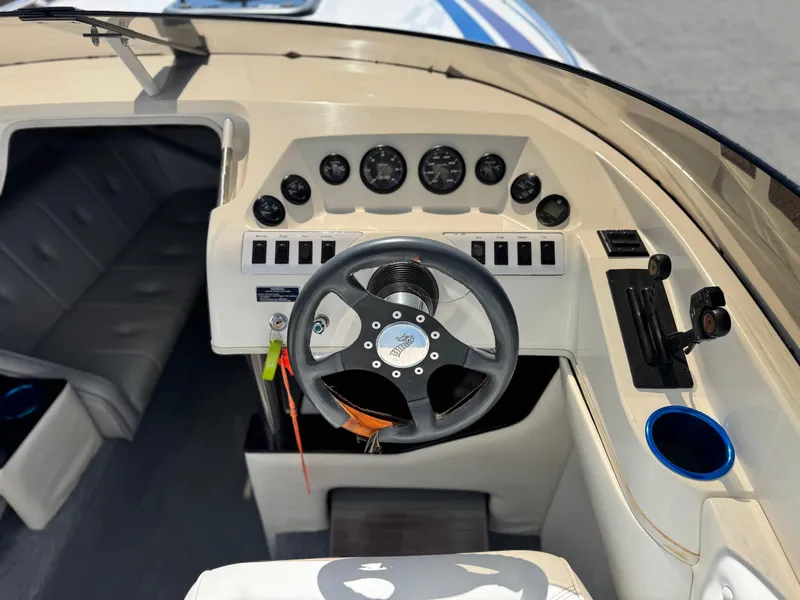 Slide: The Image of Cockpit of a 1998 Nordic 25 Scandia boat with steering wheel and instrument panel. - 24