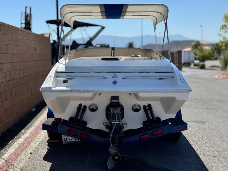 Slide: The Image of 1998 Nordic 25 Scandia boat with canopy, parked outdoors, rear view. - 4