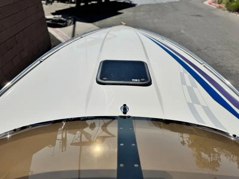 Slide: The Image of 1998 Nordic 25 Scandia boat deck with sleek design and blue accents. - 9