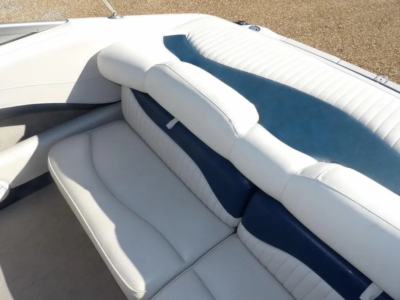 Slide: The Image of 2004 Crownline 202BR boat interior with white and blue cushioned seating. - 10