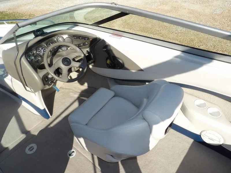 Slide: The Image of 2004 Crownline 202BR boat interior with steering wheel and dashboard controls. - 16