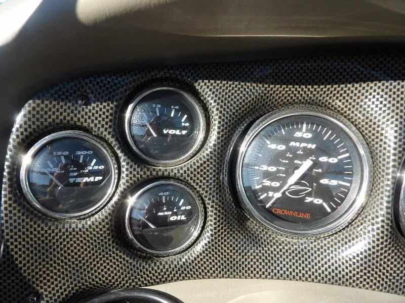 Slide: The Image of Dashboard of a 2004 Crownline 202BR boat with speedometer and gauges. - 17