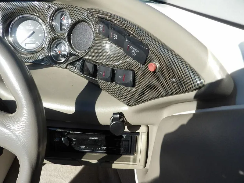 Slide: The Image of Dashboard of a 2004 Crownline 202BR boat with gauges and controls. - 19