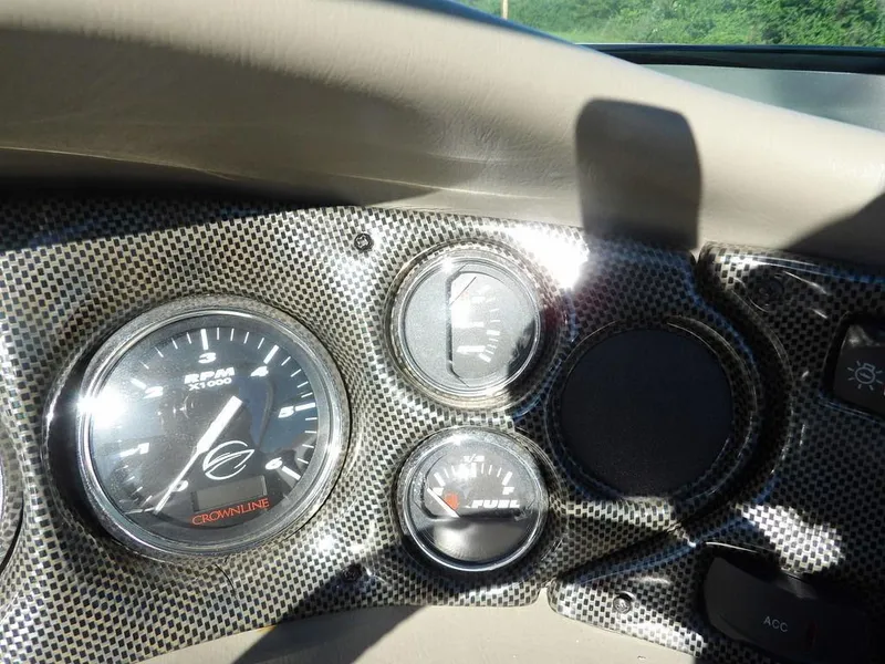 Slide: The Image of Dashboard of a 2004 Crownline 202BR boat with RPM and fuel gauges. - 20