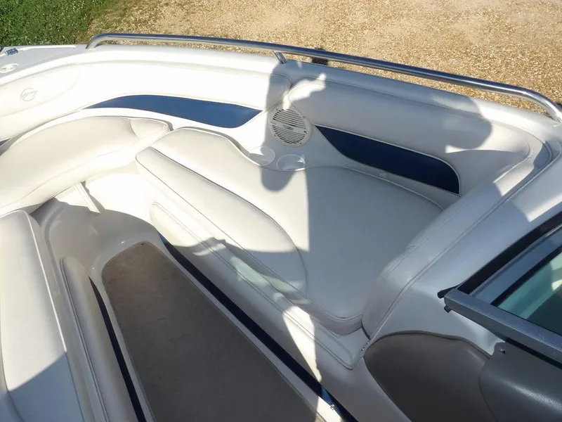 Slide: The Image of Interior of a 2004 Crownline 202BR boat with white and blue seating. - 26