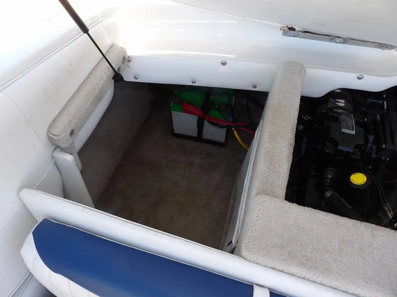 Slide: The Image of 2004 Crownline 202BR boat interior showing engine compartment and battery setup. - 27