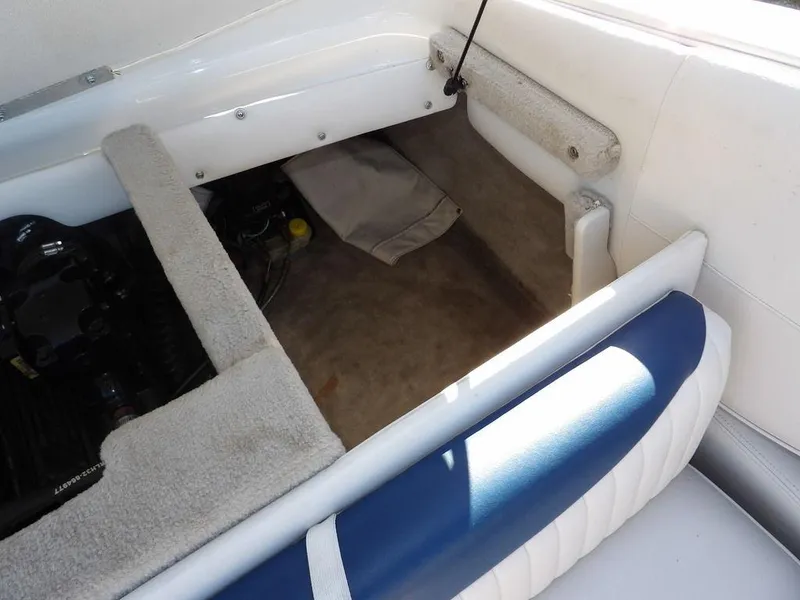 Slide: The Image of 2004 Crownline 202BR boat interior showing engine compartment and seating area. - 28